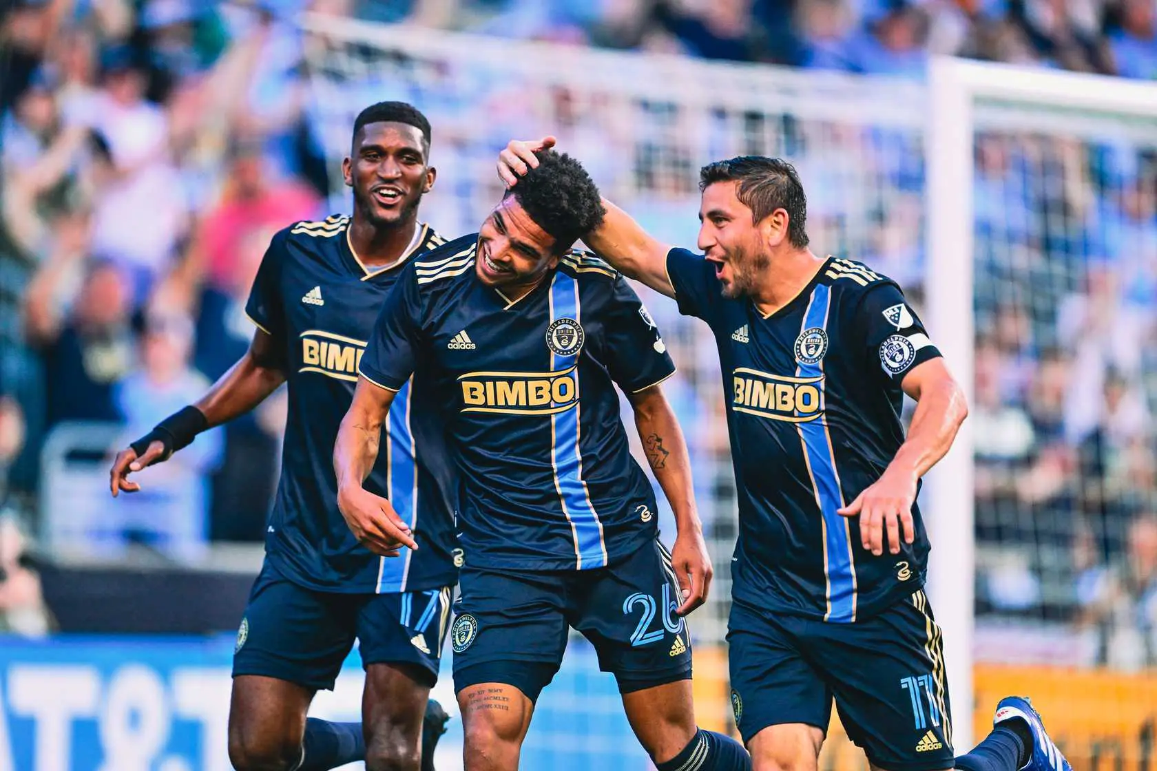 Harriel, Lowe, and Bedoya celebrating after a goal