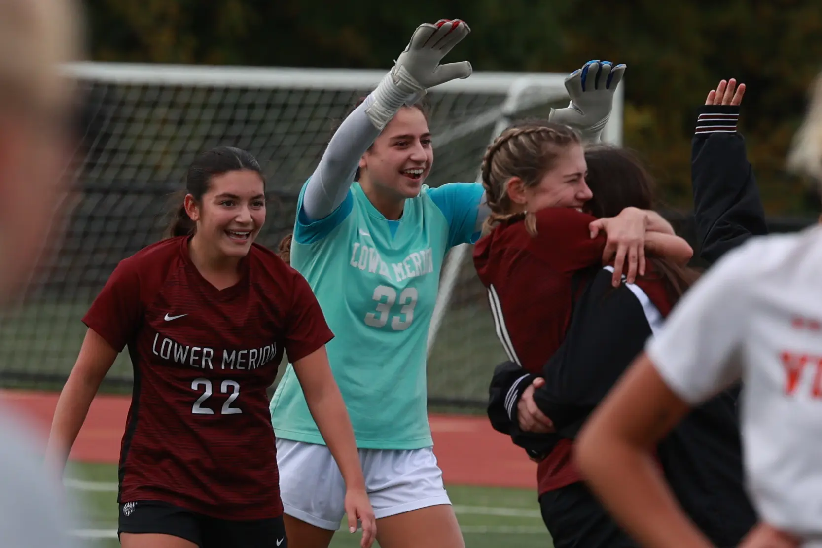 Seniors Dylan Steinberg, Cate Cantu and Kendall Baker celebrate Lower Merion's 1-0 win over Perkiomen Valley in the PIAA District 1 playoffs on October 23, 2025.