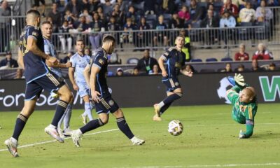 Soccer ball on grass that is heading towards Atlanta United's goalkeeper