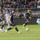 Soccer ball on grass that is heading towards Atlanta United's goalkeeper