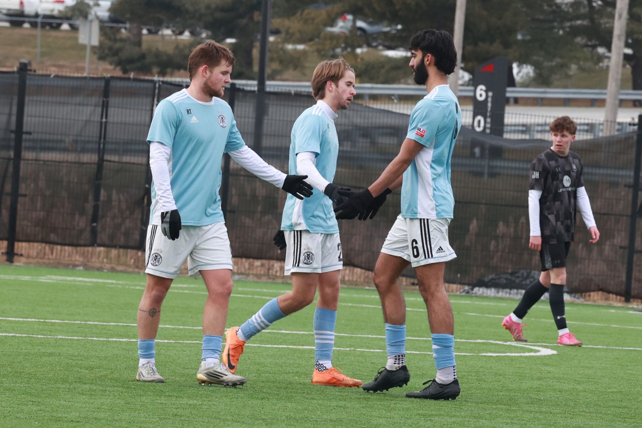Dylan Lacy (middle) celebrates his hat trick with West Chester United teammates